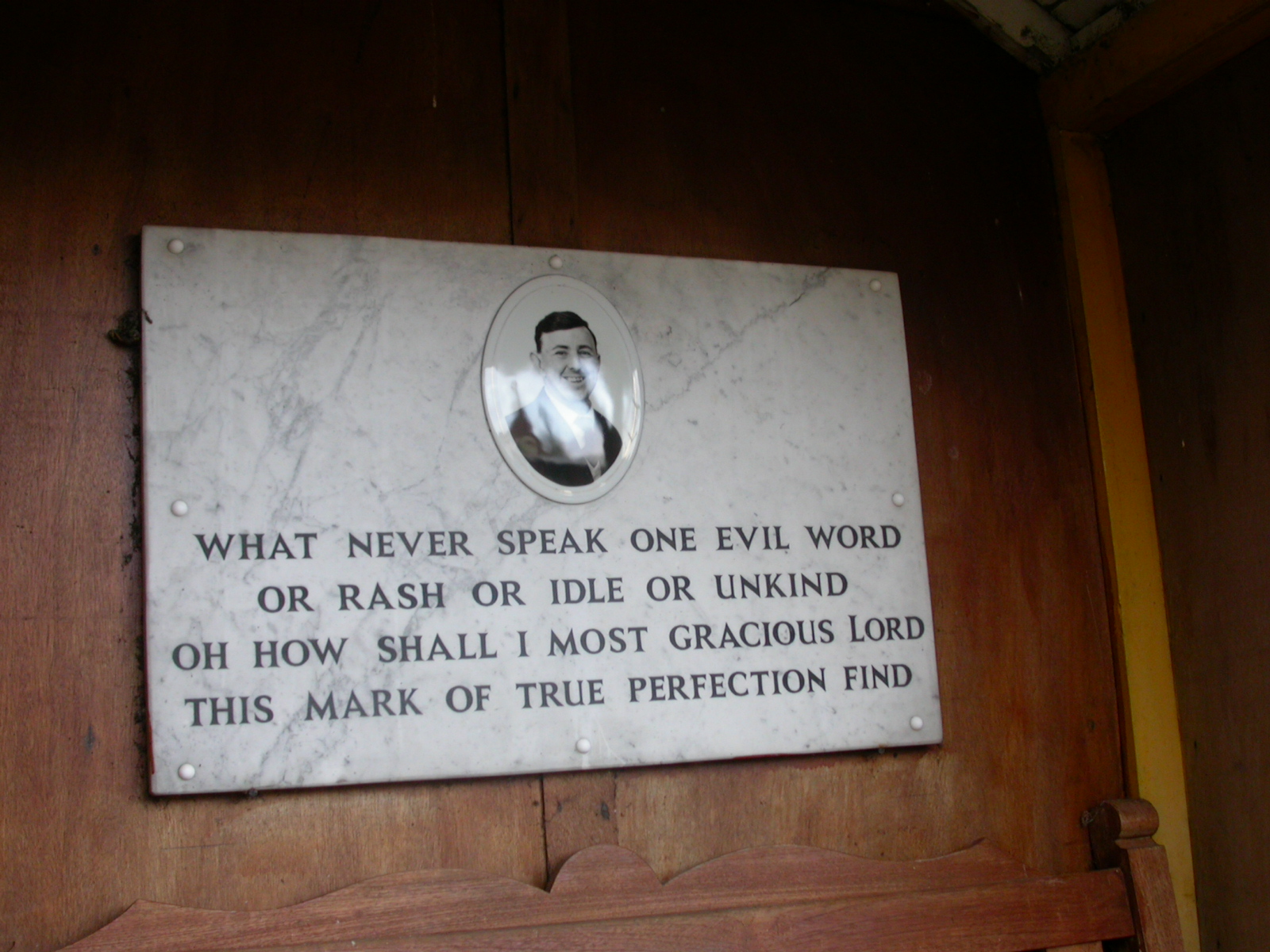 Memorial to Edwin Fairnington. a marble plaque with his picture and the text below
