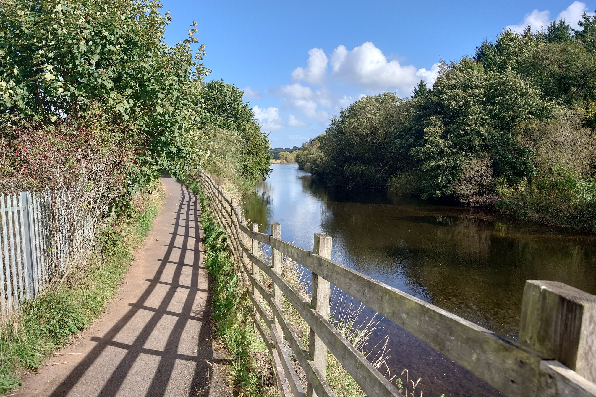 A broad path follows the broad River Caldew, with trees on both sides
