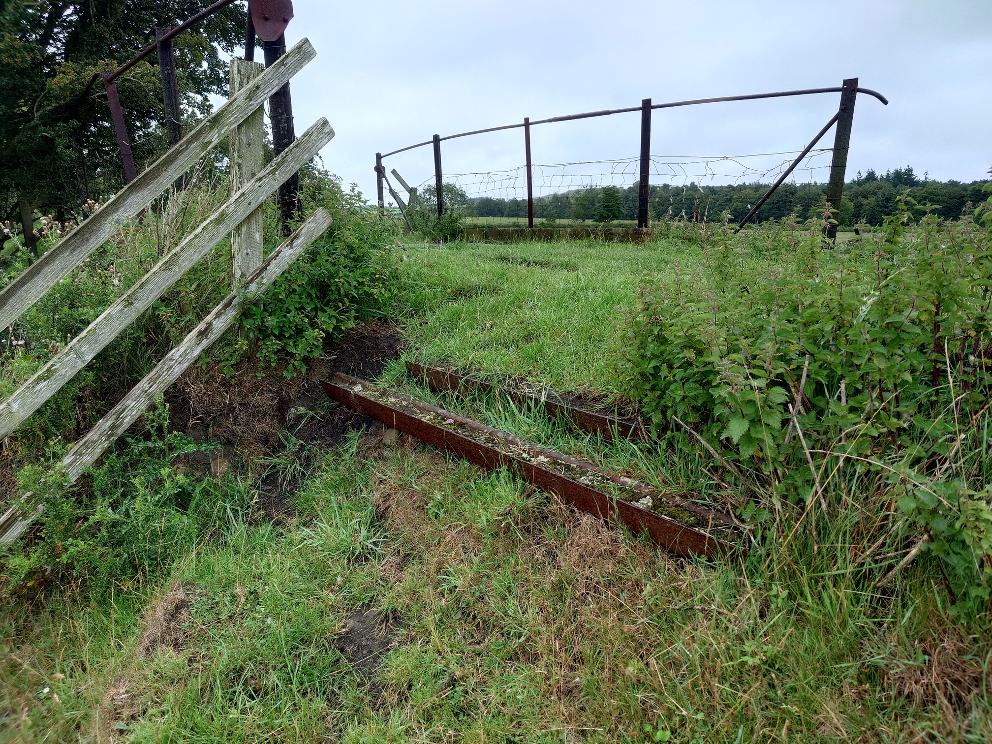 By the bridge, the top of the track has been shored up with rusty old rails to stop the embankment colapsing down